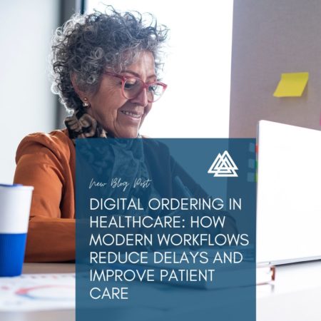 Healthcare employee smiling in front of computer